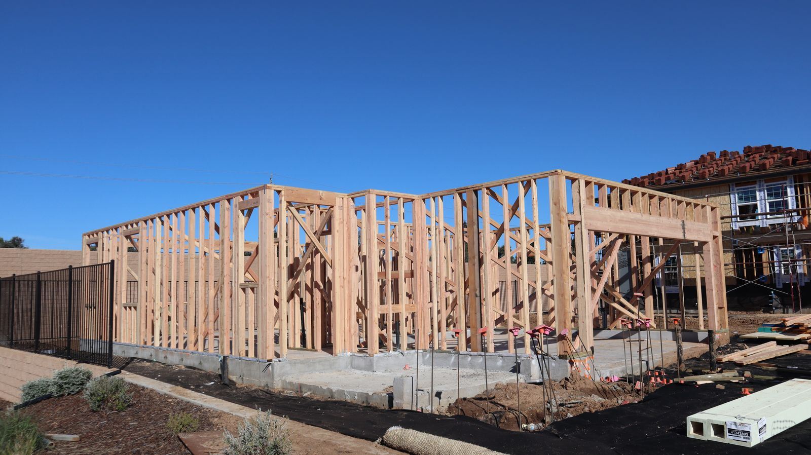 A house under construction with its timber frame exposed